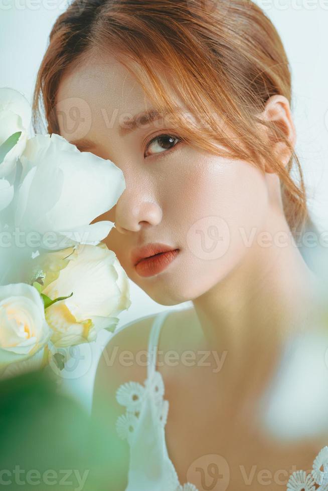 Portrait of beautiful asian girl in hand bouquet, isolated on white background photo