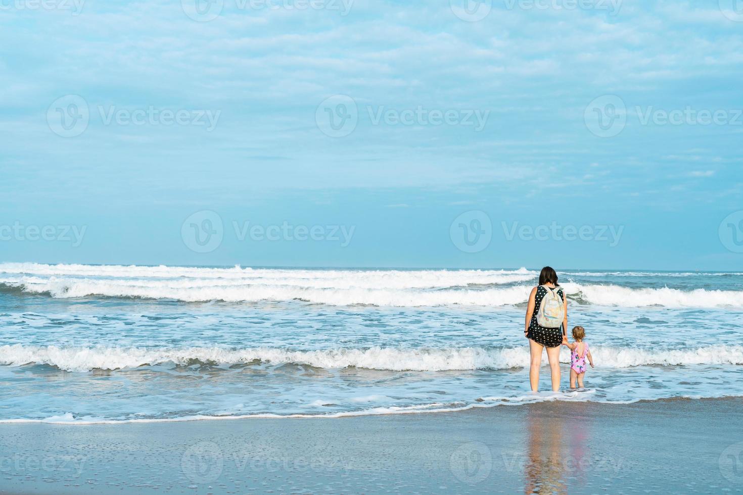 vacation, mom and daughter on the beach, sand, holds the hand photo