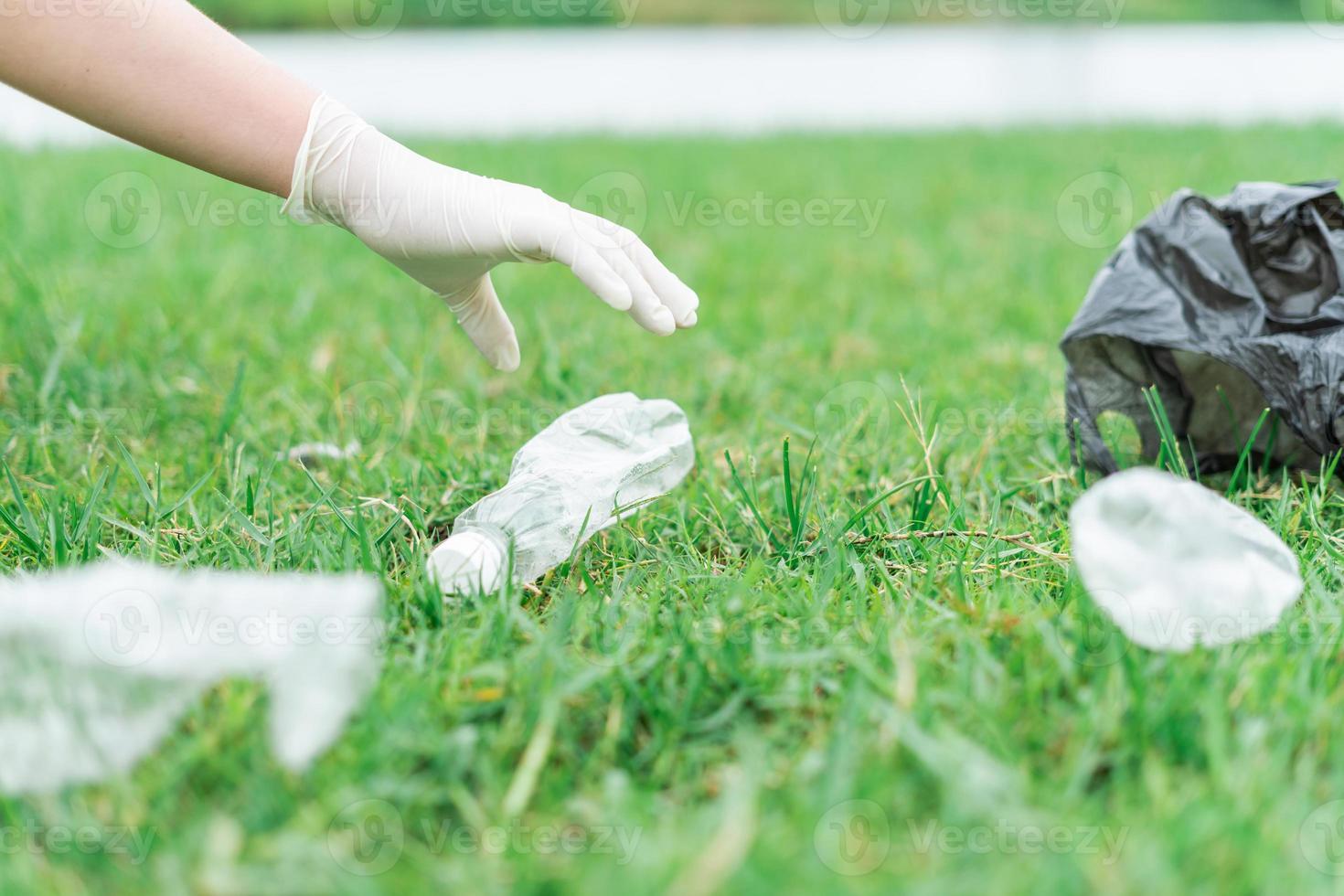 The man volunteered to collect garbage on the lawn photo