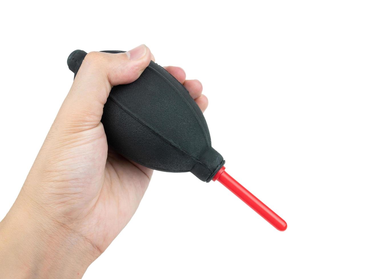 Hand holding Silicone blower or Rubber air blower Pump Dust Cleaner for camera and lenses isolated on white background, Clipping path photo