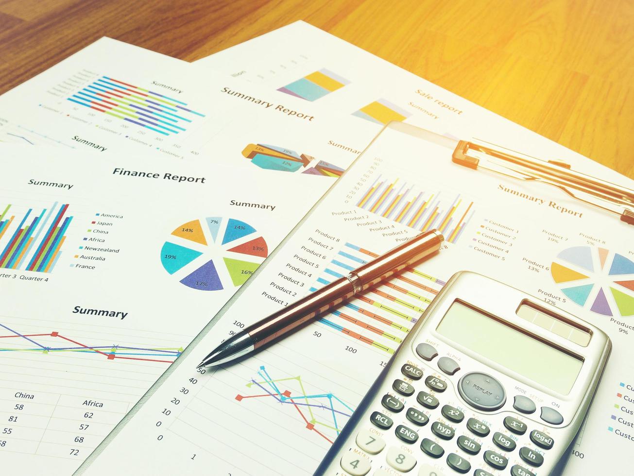 Business report chart and Financial graph analysis with pen and calculator on table photo