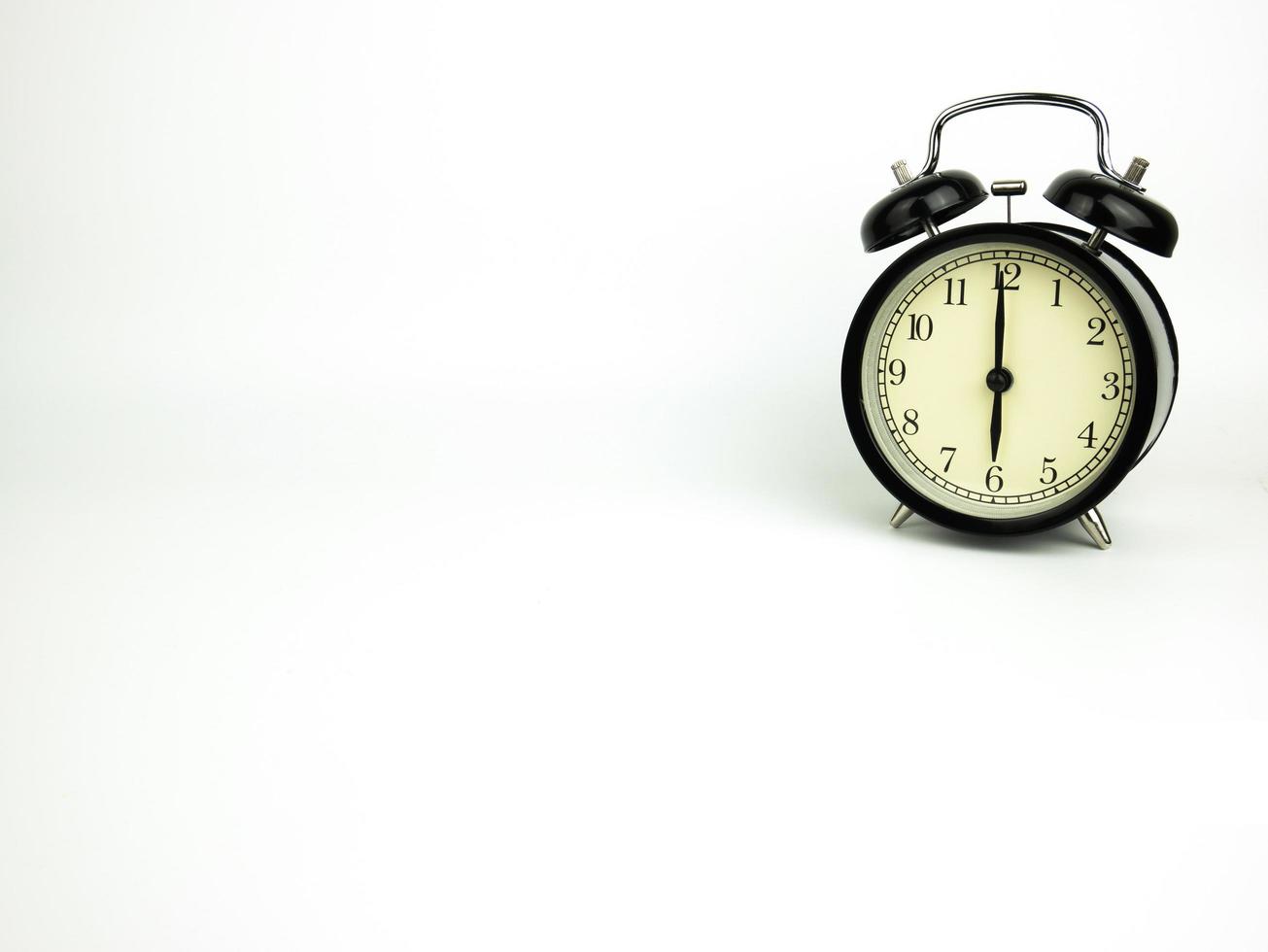 Blank notebook with alarm clock and on white background photo