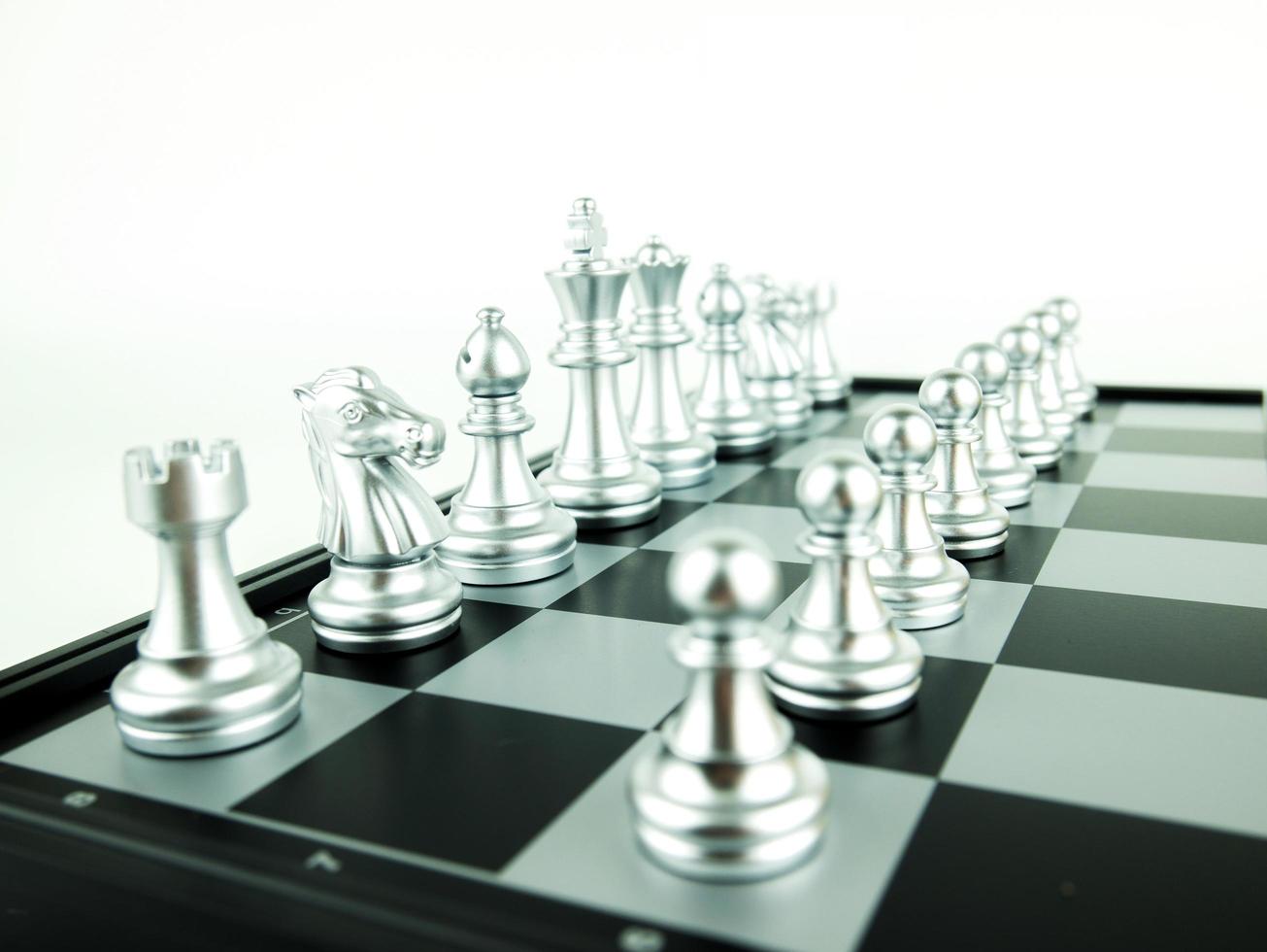 Silver chess figures on board for game start, Intellectual sport and Tactic game photo