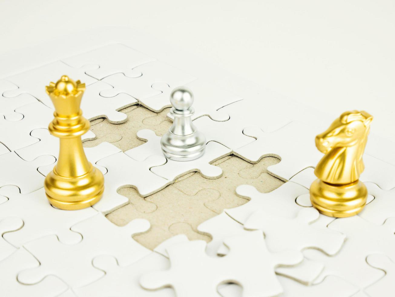 Glod and Sliver chess piece on jigsaw puzzle background, business concept photo