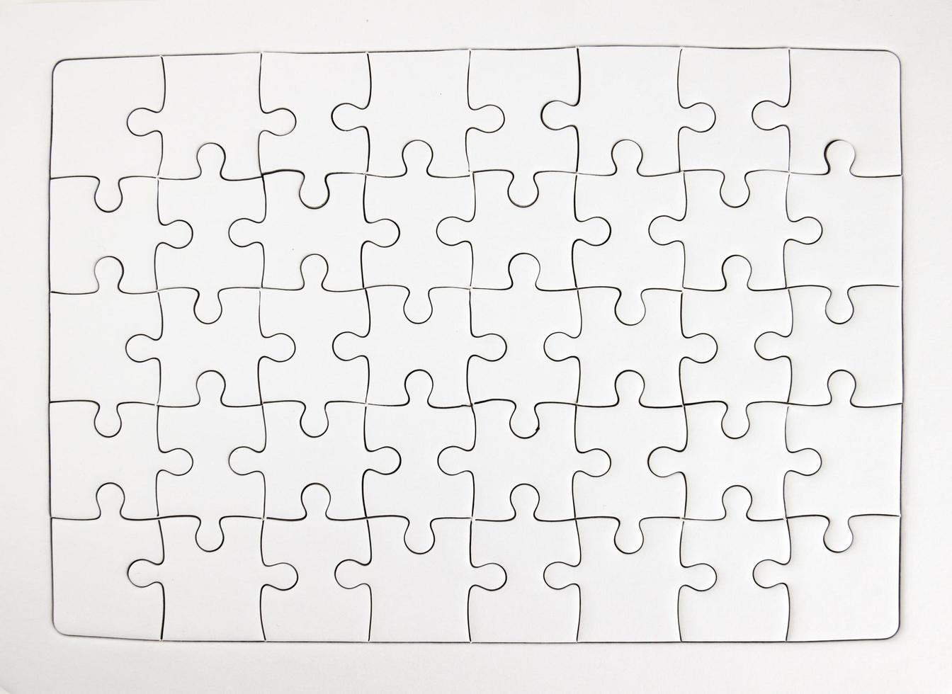 White jigsaw puzzle pieces completed as copy space photo