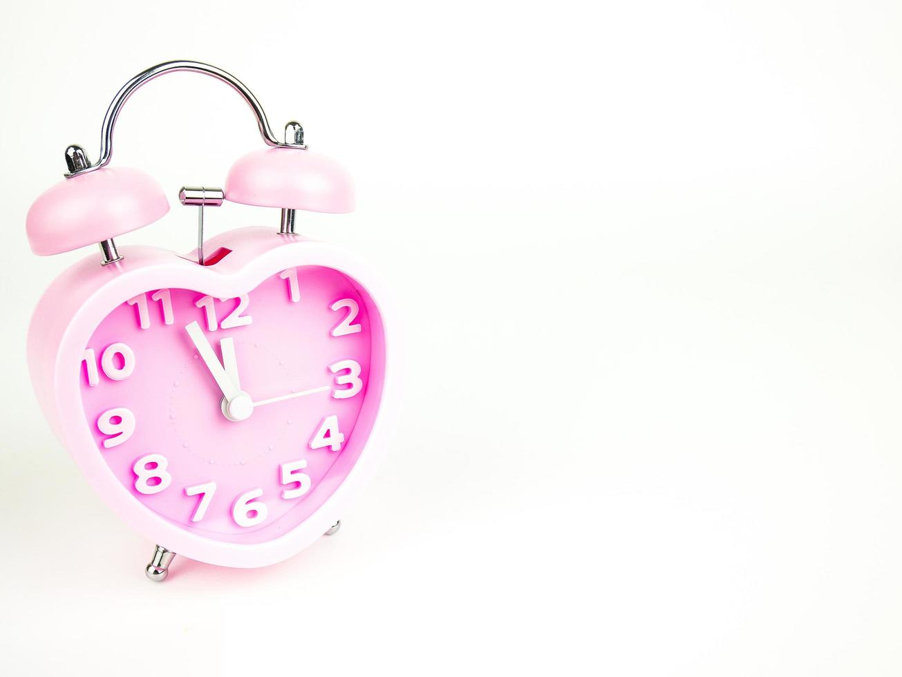 Pink alarm clock in the form of heart isolated on white background, Valentine's Day photo