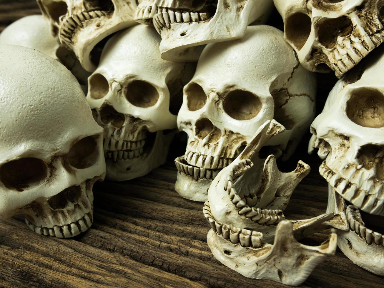 Awesome pile of skull and bone on old wooden background, Still Life style, selective focus, Halloween photo