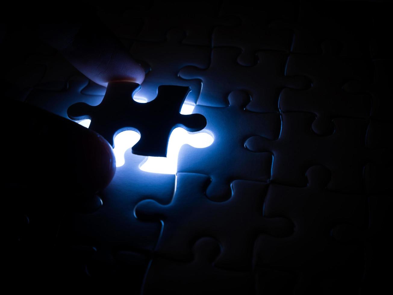 Missing Jigsaw puzzle piece with lighting, business concept for completing the finishing puzzle piece photo