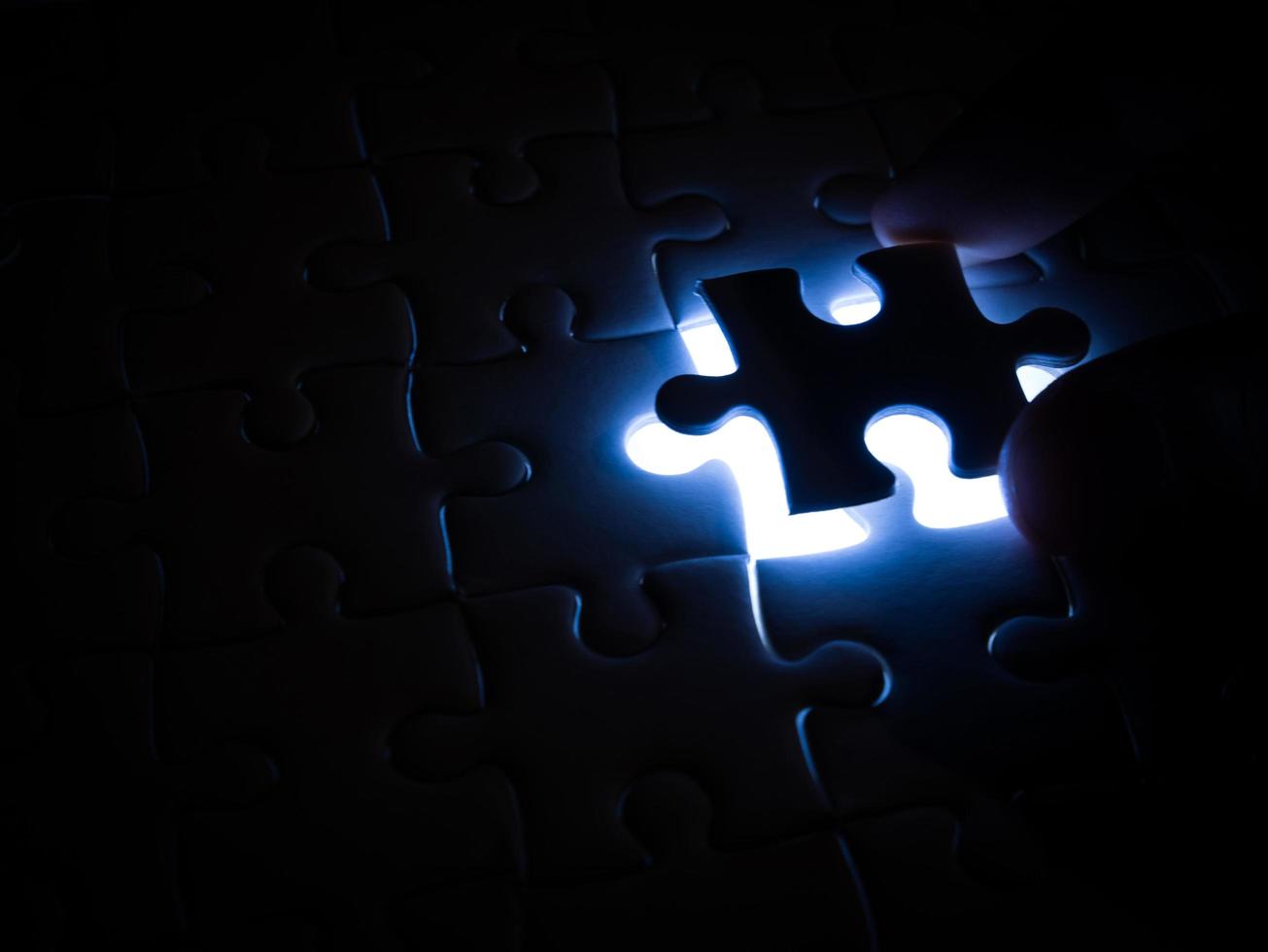 Missing Jigsaw puzzle piece with lighting, business concept for completing the finishing puzzle piece photo