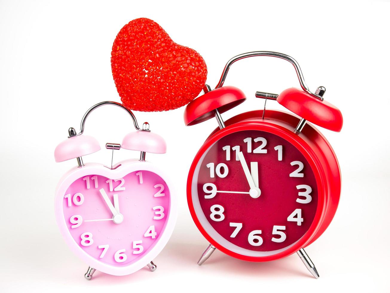 Red and Pink alarm clock in the form of heart isolated on white background, Valentine's Day photo