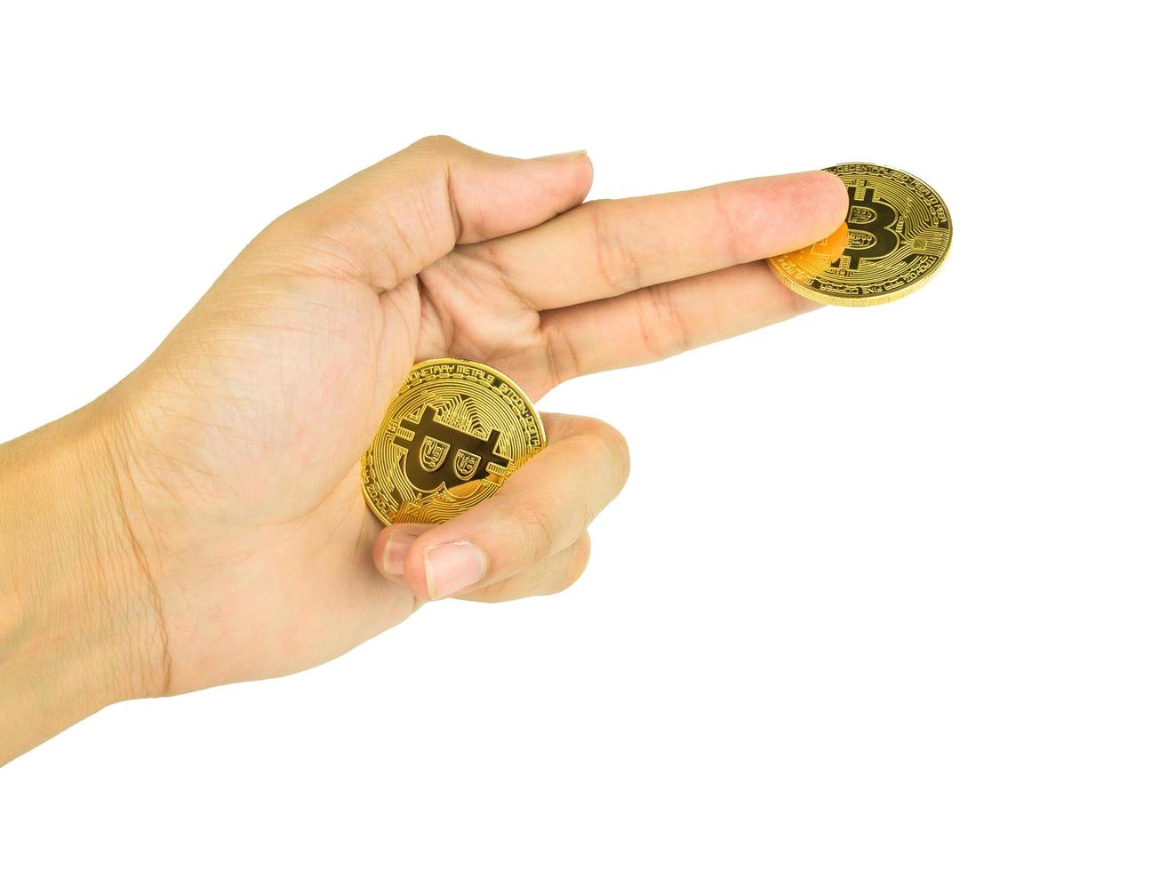 Hand hold Bitcoin Cryptocurrency Digital isolated on white background with Clipping path, BTC Currency Technology Business Internet Concept photo