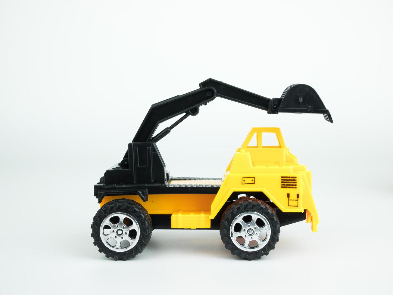 Toy Mechanical digger on white background, Engineering construction concept photo