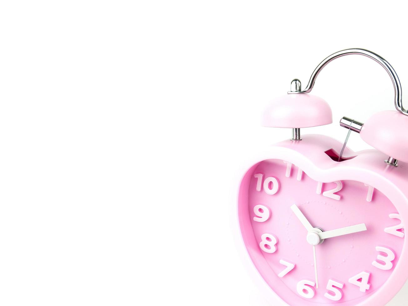 Pink alarm clock in the form of heart on white background, Clipping path photo