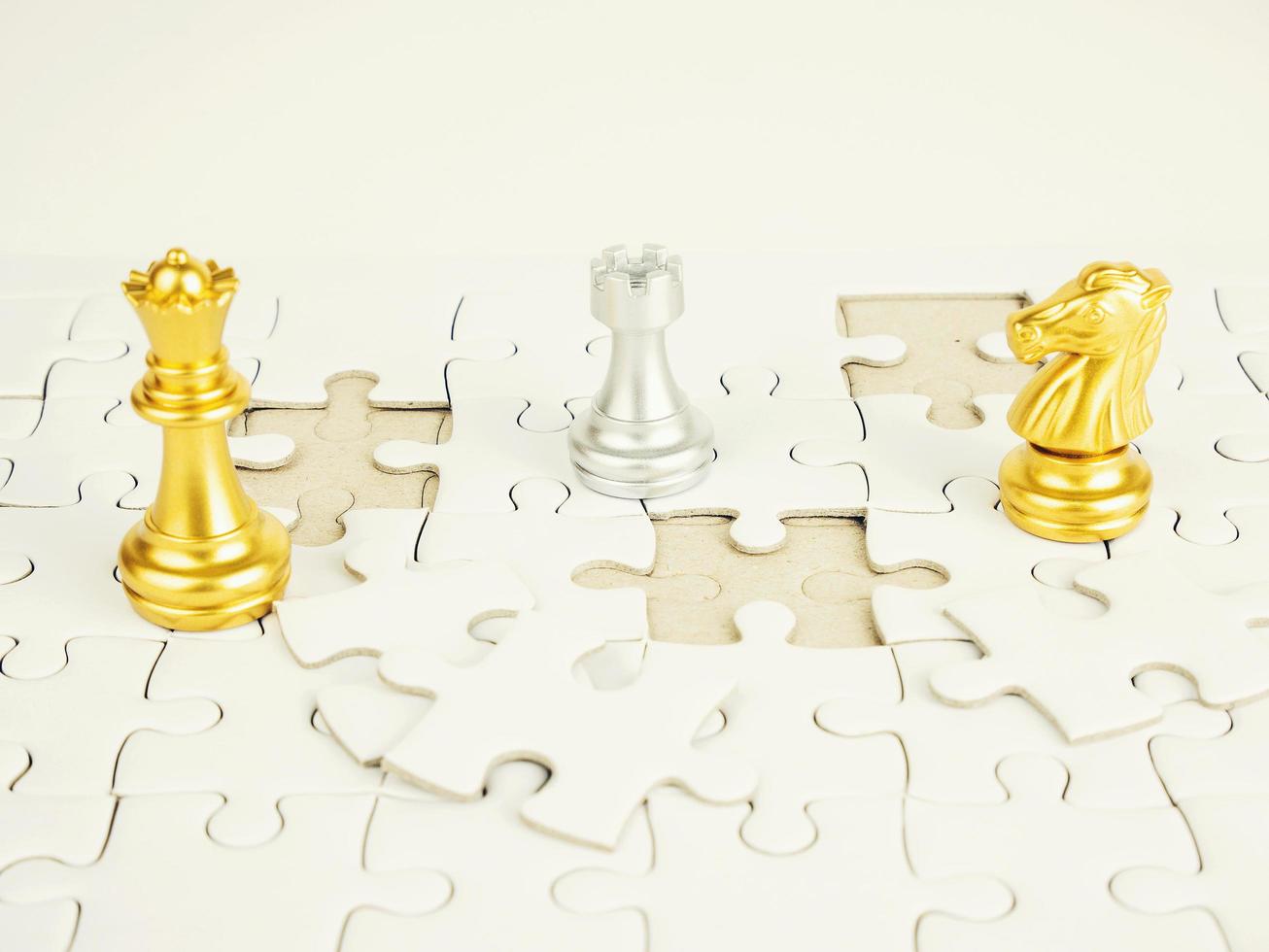 Glod and Sliver chess piece on jigsaw puzzle background, business concept photo