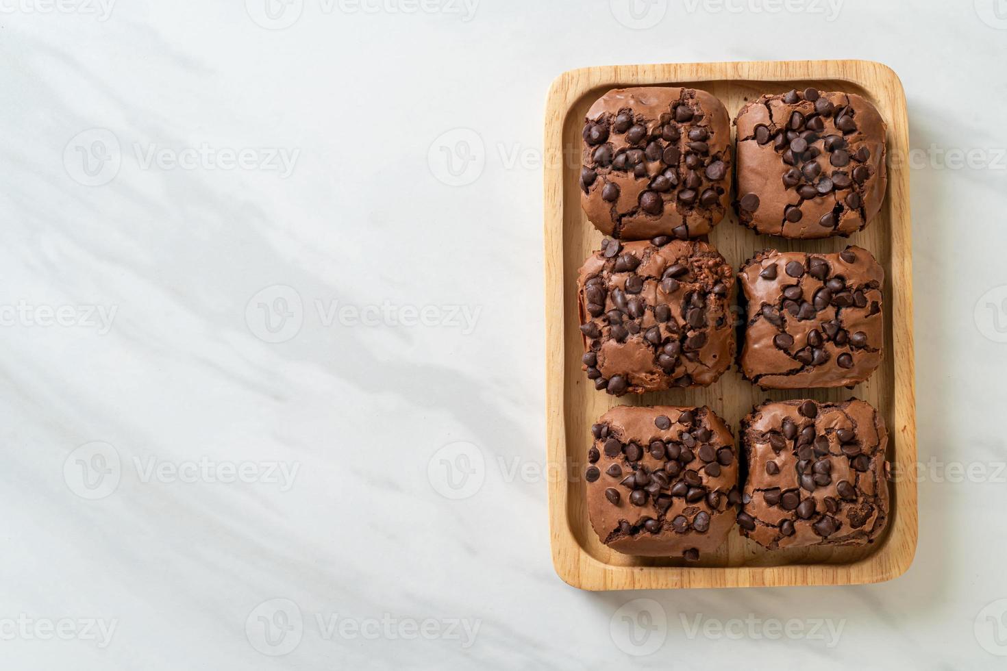 dark chocolate brownies topped by chocolate chips photo