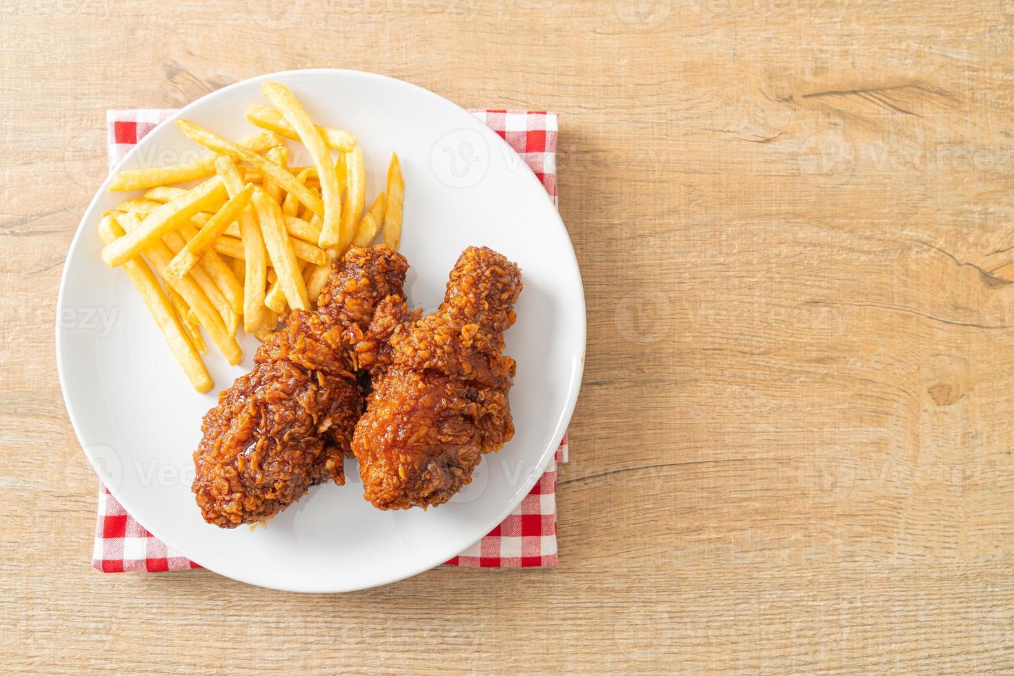 spicy Korean fried chicken with fries photo