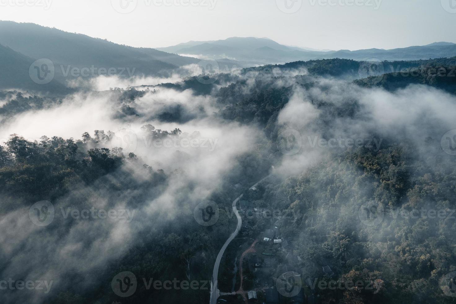 The sun rises in the mist and mountains in the morning photo