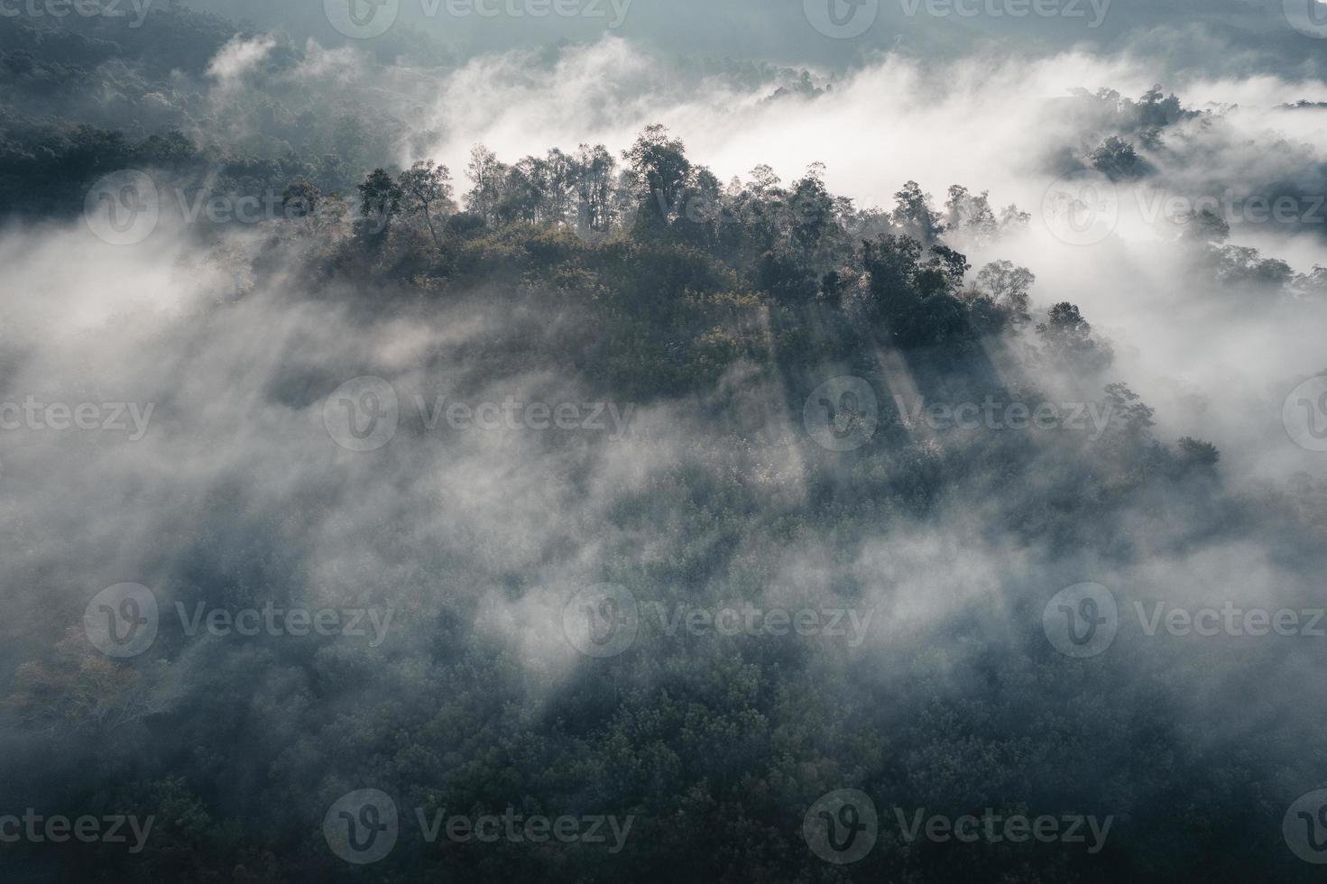 The sun rises in the mist and mountains in the morning photo