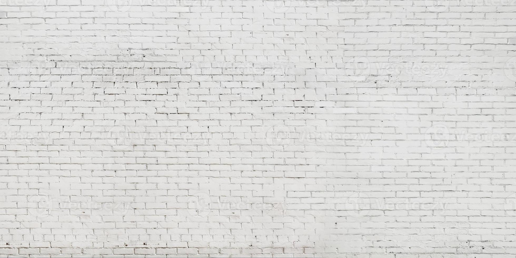 Fondo de una vieja pared pintada de blanco de ladrillo foto