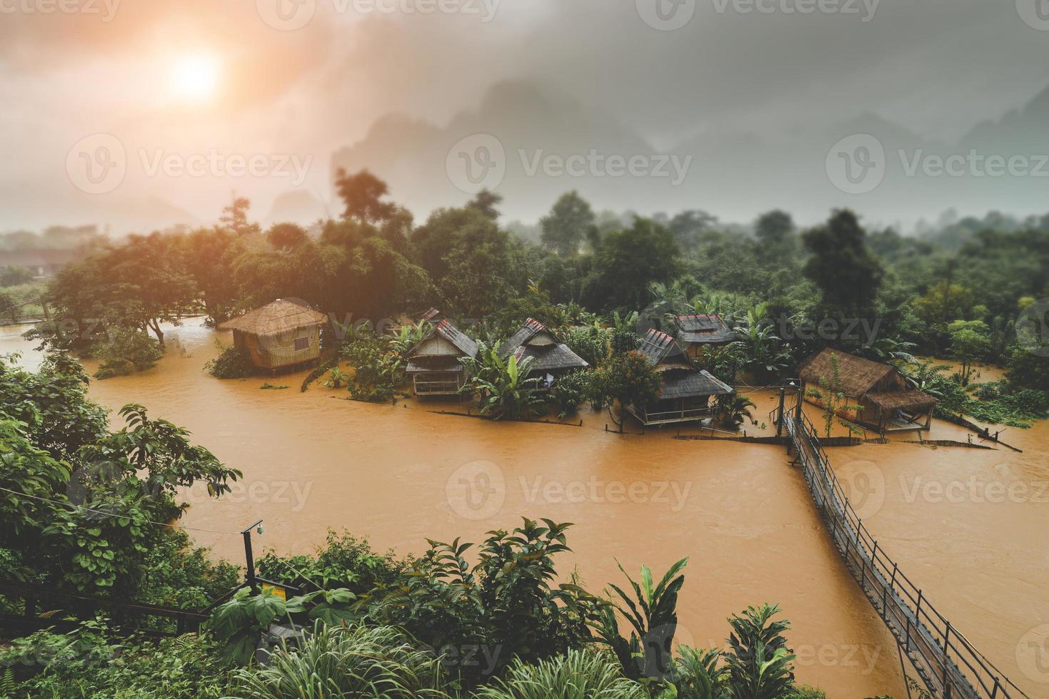 Country side village in floating river and the raining fog weather. photo