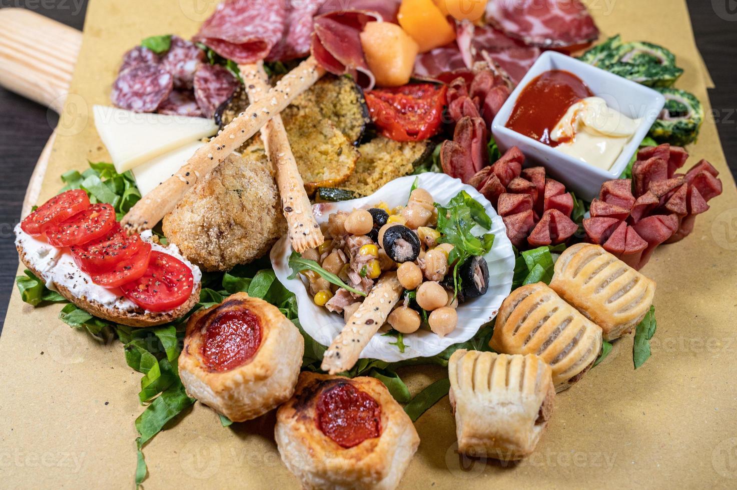 mixed antipasto platter with cold cuts and legumes and cheeses photo