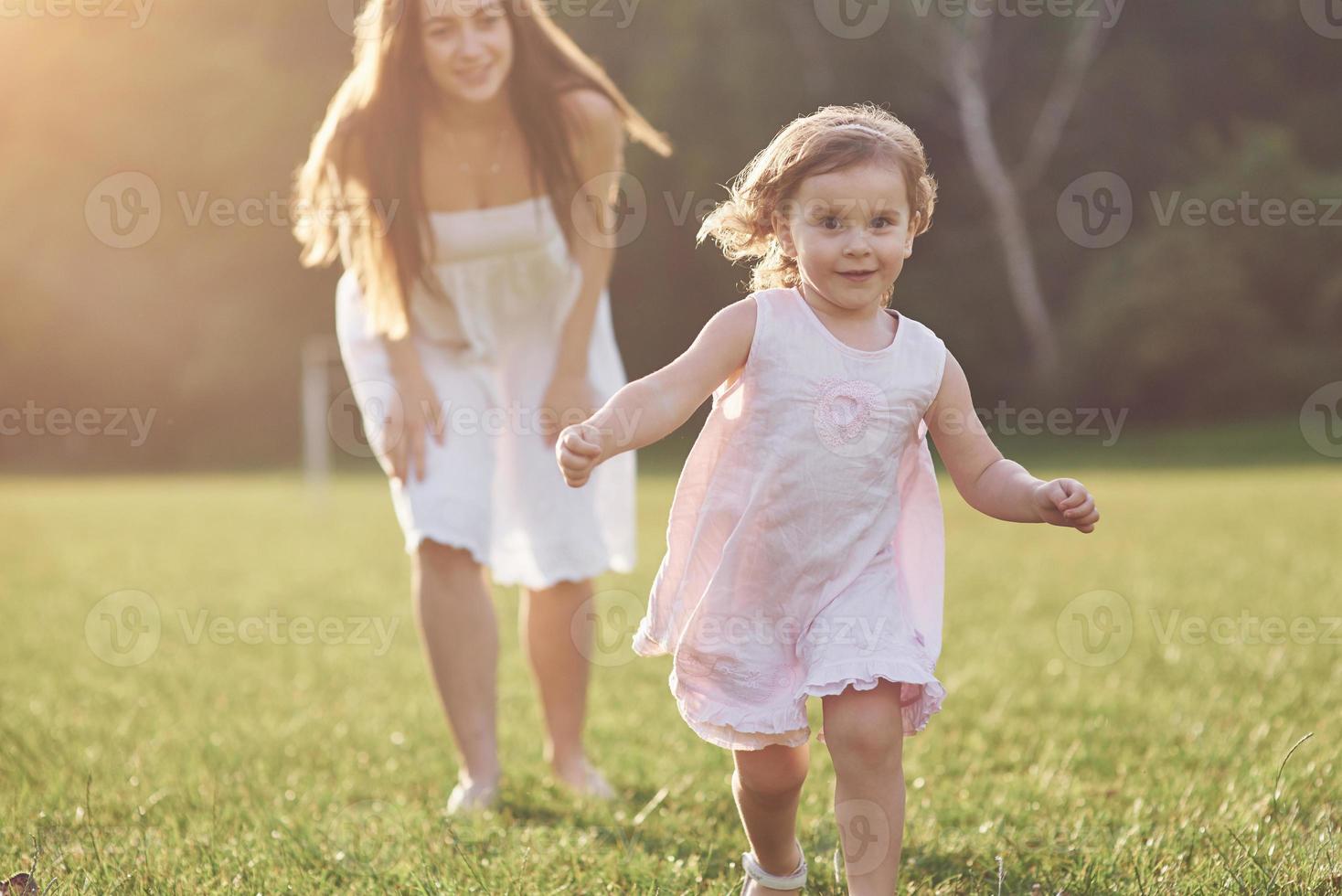 Happy family, active mother with little child, adorable toddler girl photo