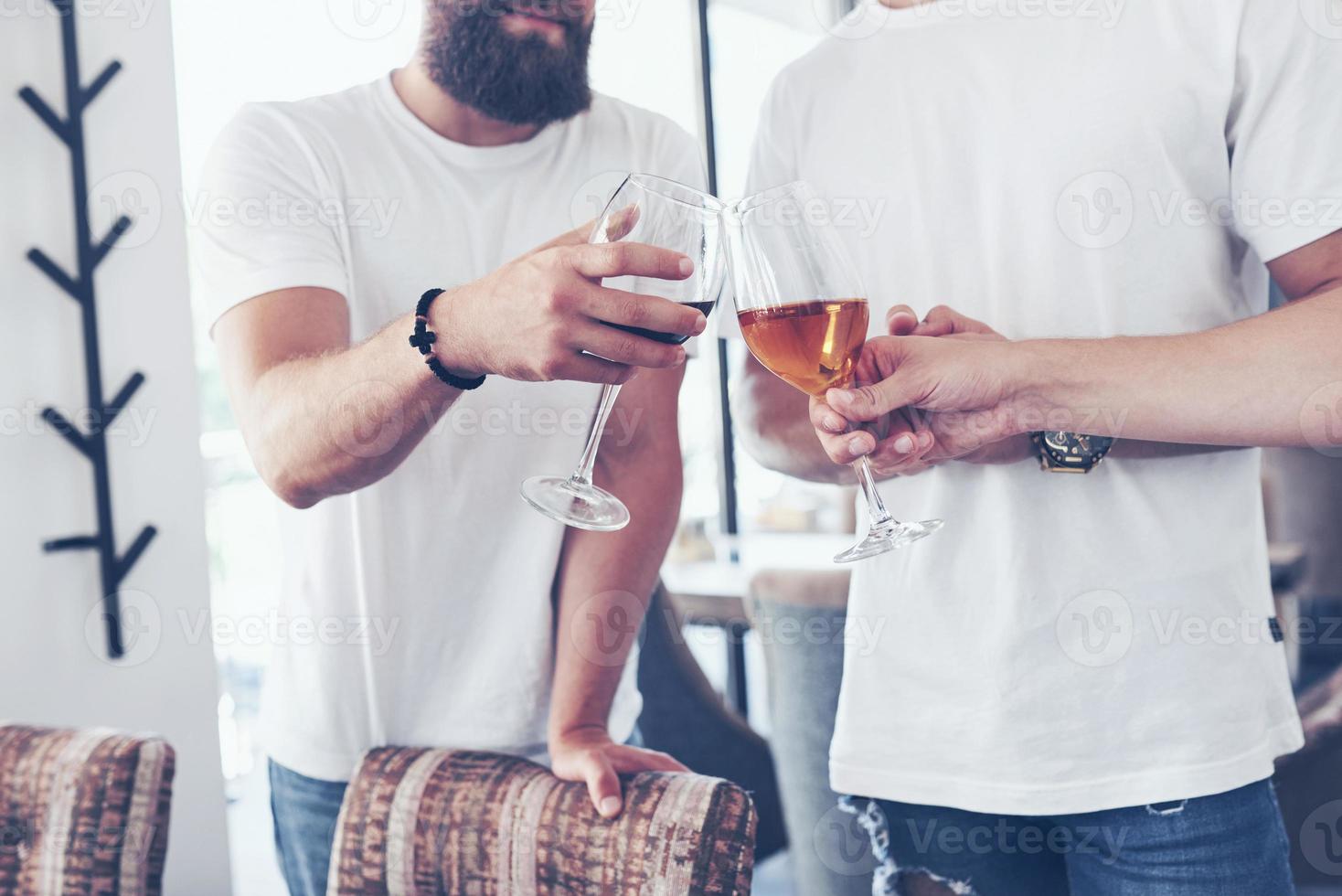 Cheerful old friends communicate with each other glasses of whiskey in pub. Concept entertainment and lifestyle photo