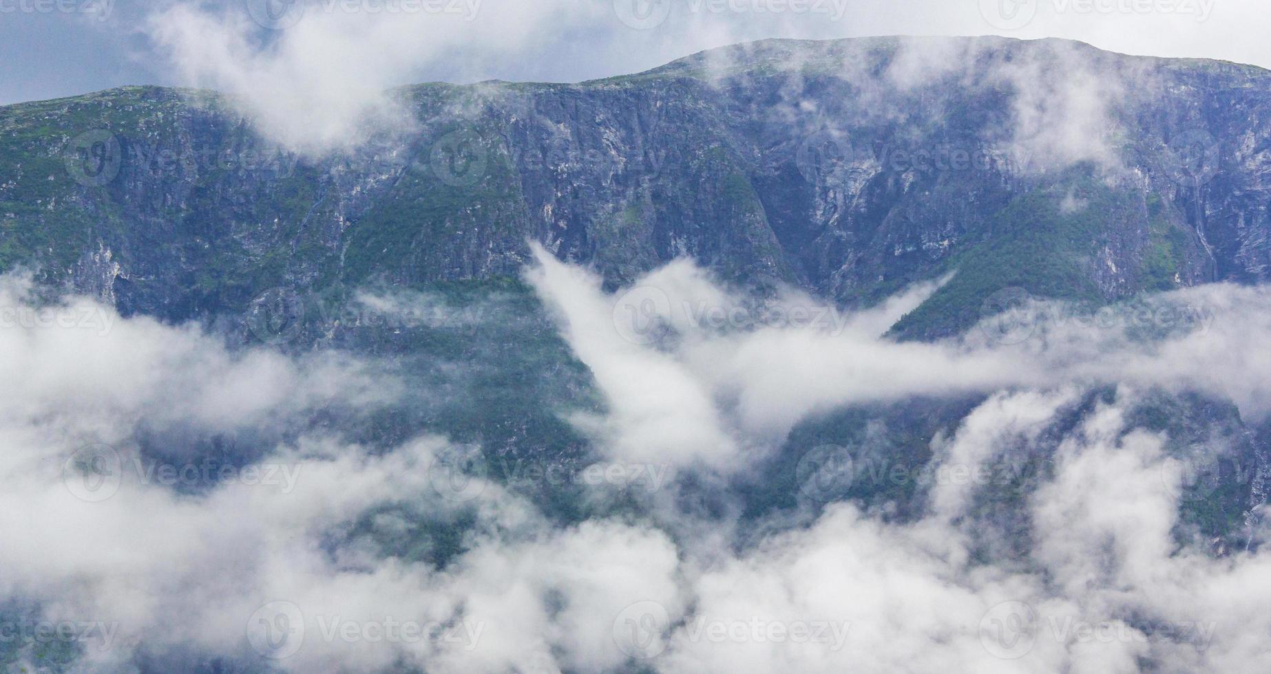 Fog mist clouds cliffs on mountain norwegian landscape Jotunheimen Norway. photo