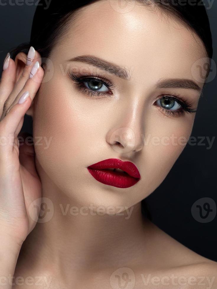 Woman with red matte finish lips closeup portrait photo