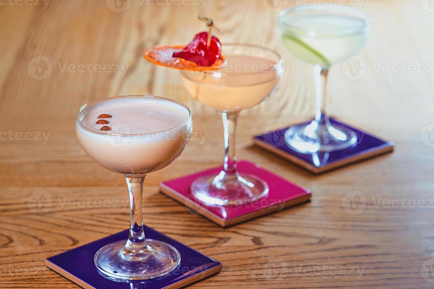 different colorful alcohol and non-alcohol cocktails in the glasses on the table photo