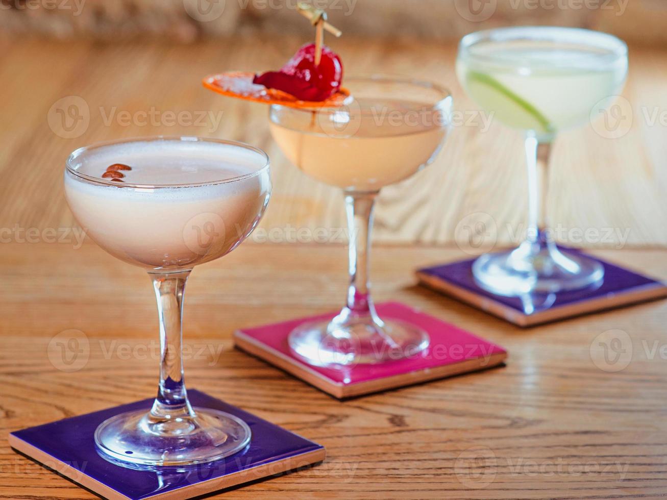 different colorful alcohol and non-alcohol cocktails in the glasses on the table photo