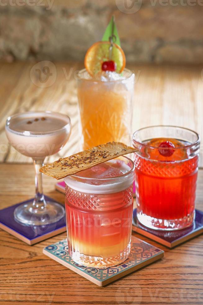 different colorful alcohol and non-alcohol cocktails in the glasses on the table photo