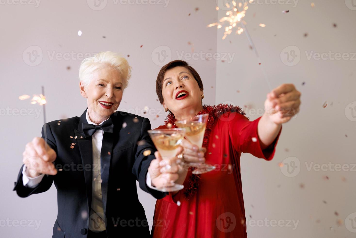 Two beautiful stylish mature senior women celebrating new year. Fun, party, style, celebration concept photo