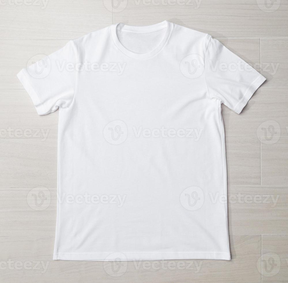 Blank white T-shirt mockup template on the floor photo