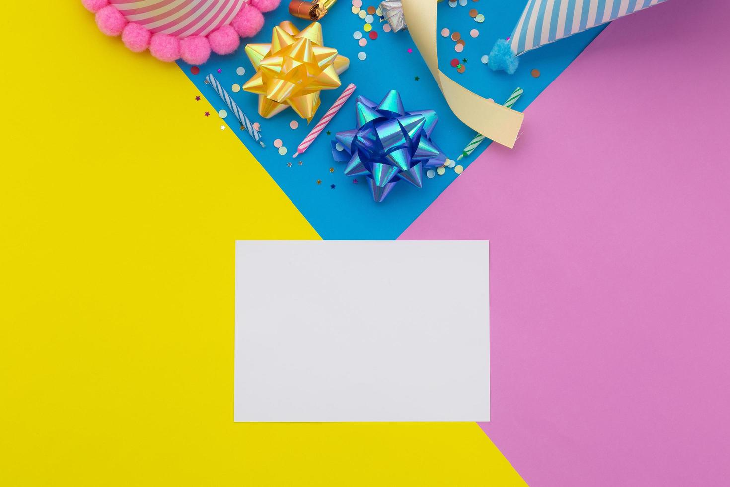 Happy birthday background, Flat lay colorful party decoration with flyer invitation card on pastel yellow, blue and pink geometric background photo