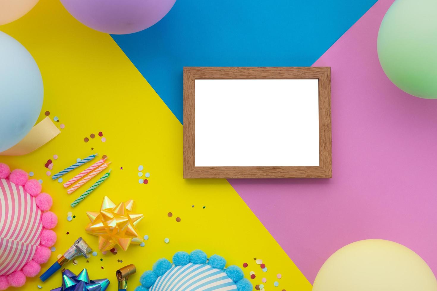 Happy birthday background, Flat lay colorful party decoration with flyer invitation card on pastel yellow, blue and pink geometric background photo