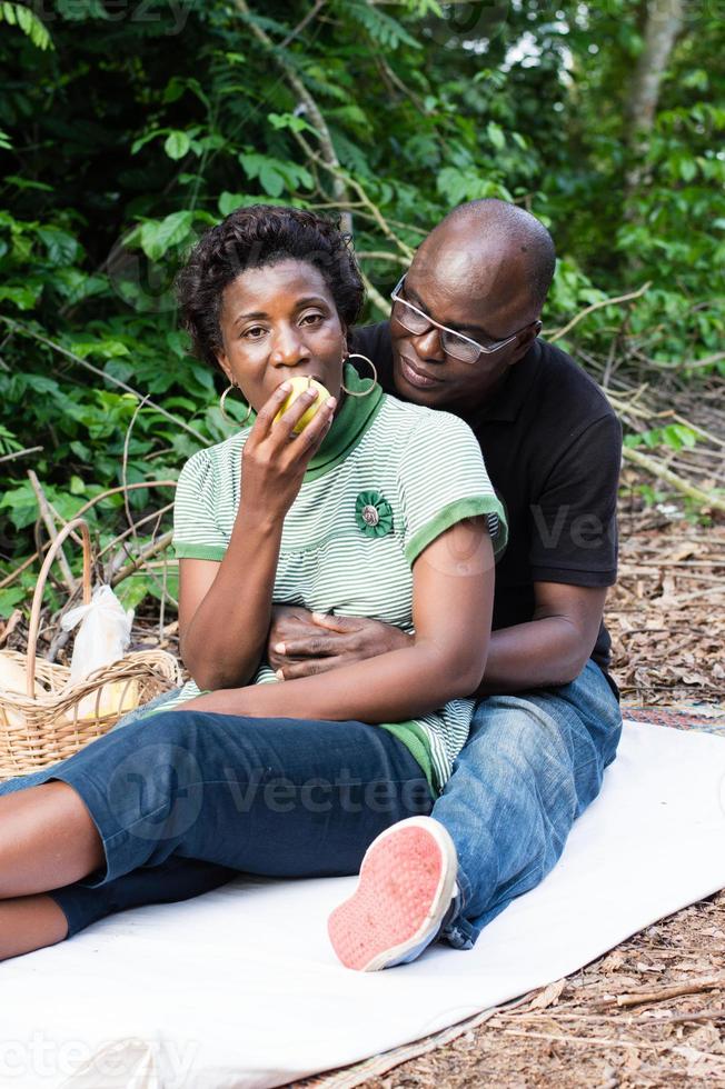 love couple sitting on a mat in the bush. photo