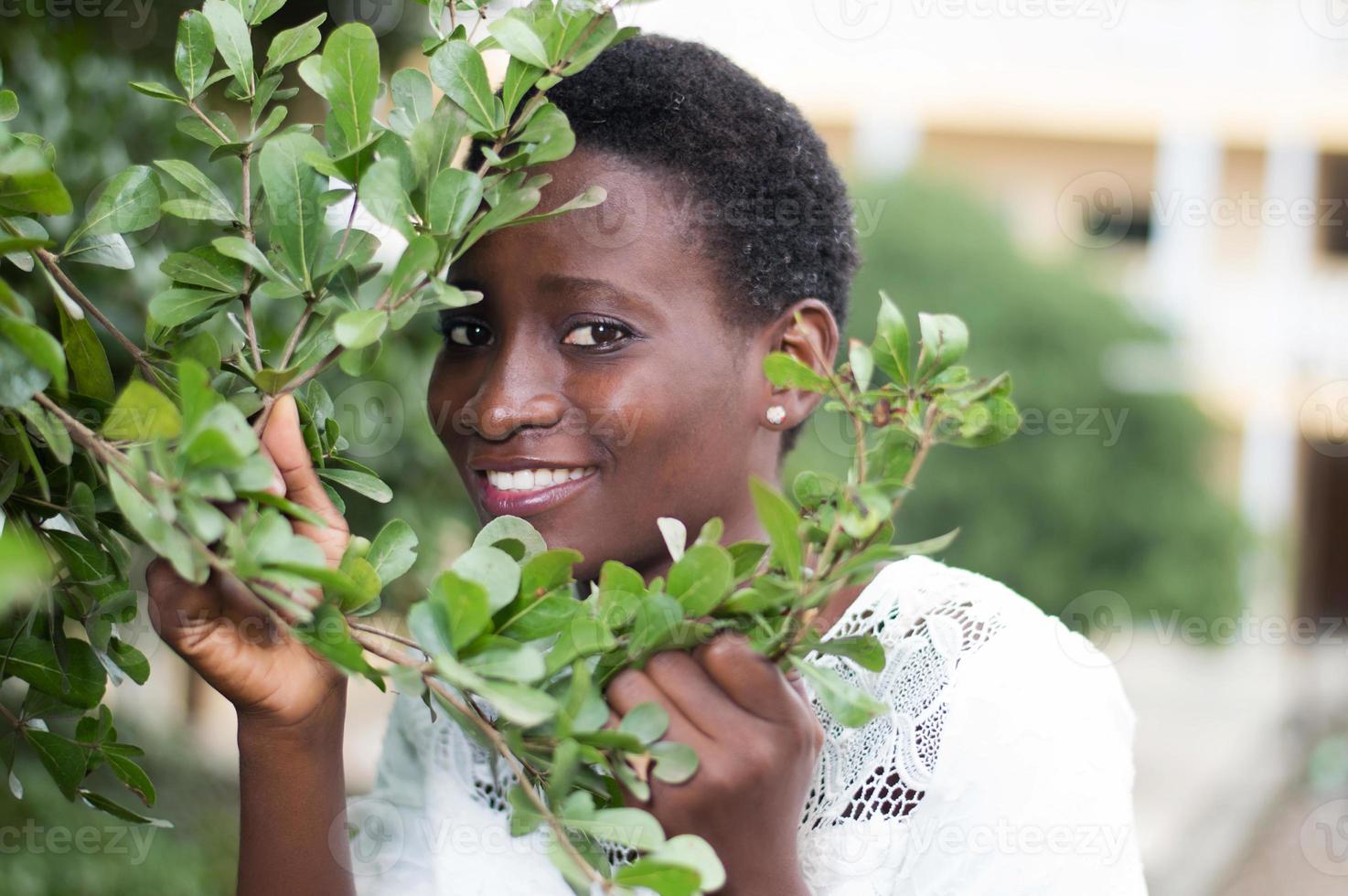 young woman hidden behind the foliage. photo