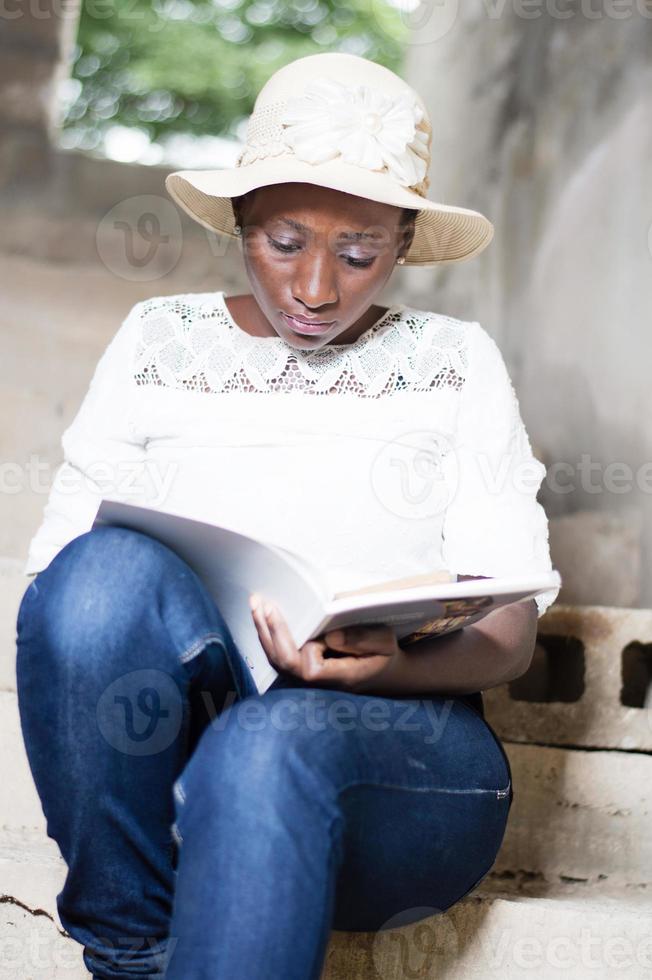 beautiful young woman doing the reading. photo