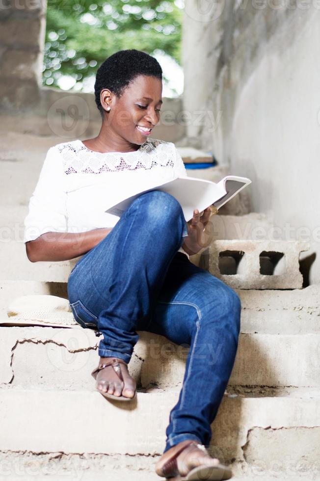 smiling young woman doing the reading. photo