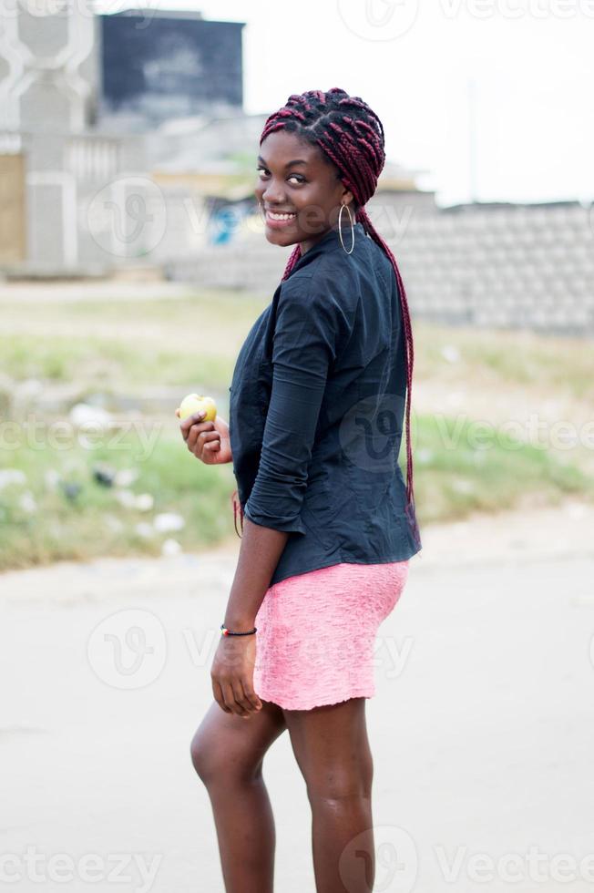 smiling young woman holding an apple. photo