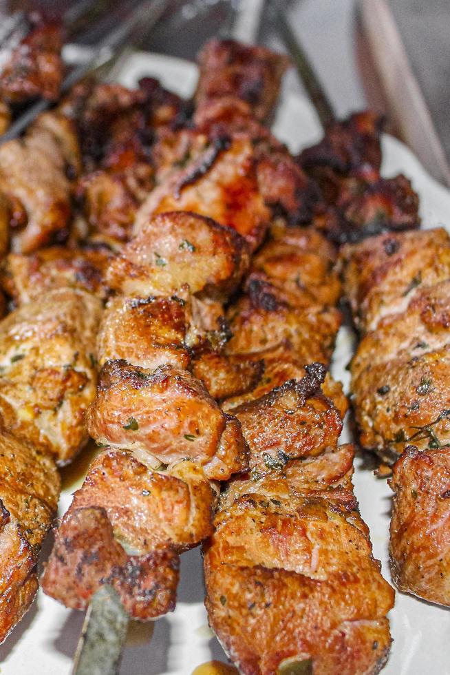 Russian shashlik with skewers on a white plate background. photo