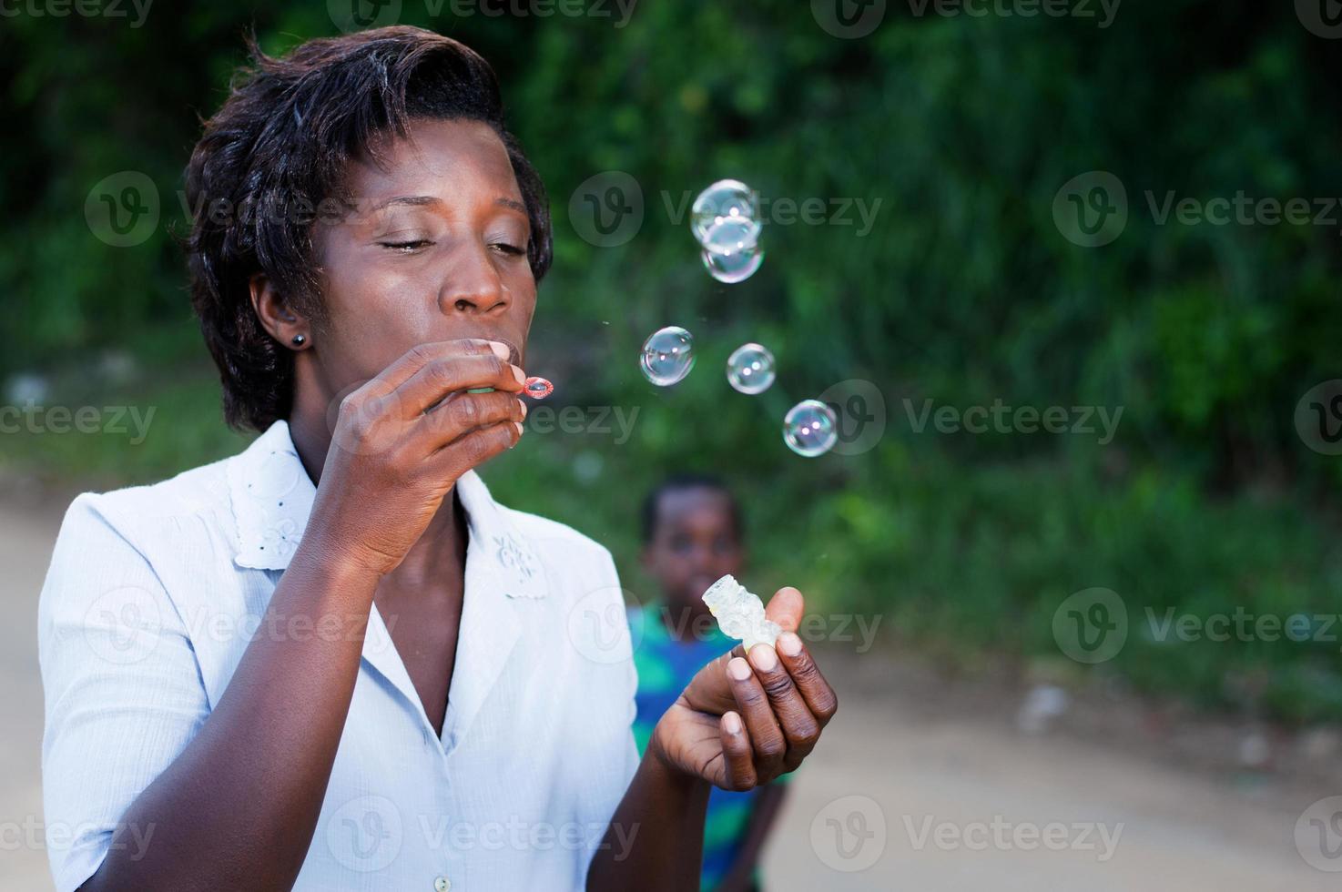 pretty young woman blowing bubbles. photo