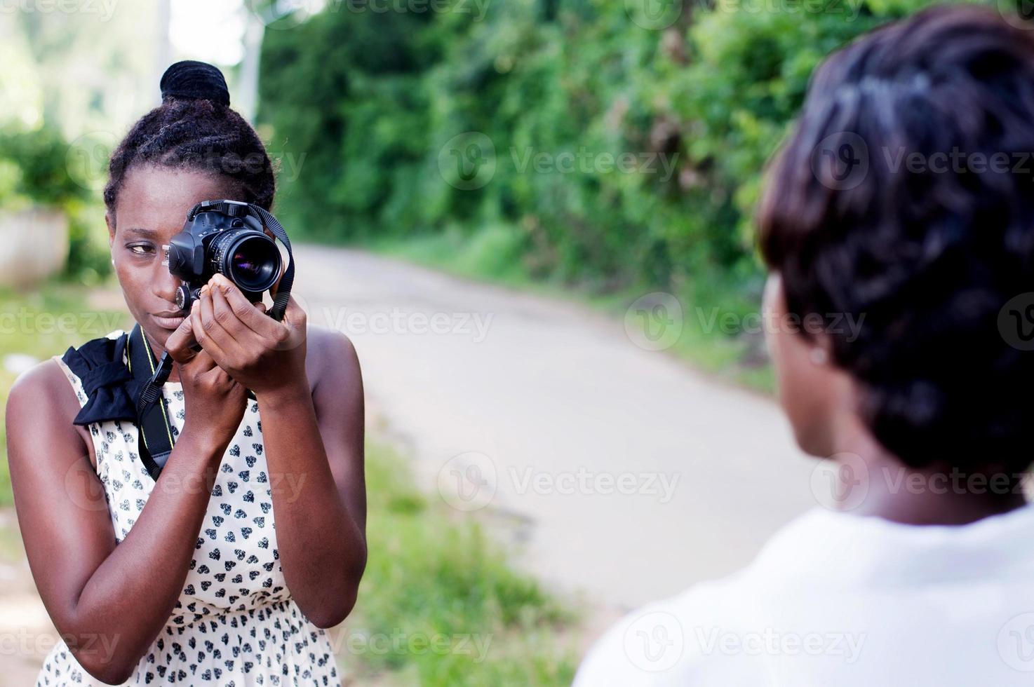 young woman taking a photo with her girlfriend.