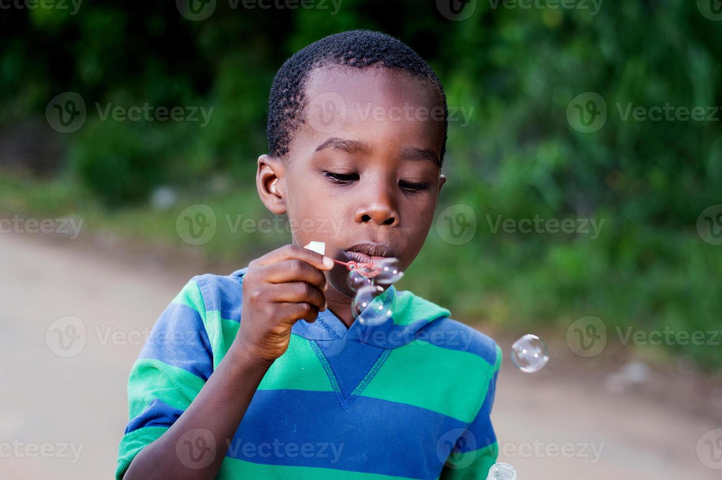 child blowing bubbles. photo