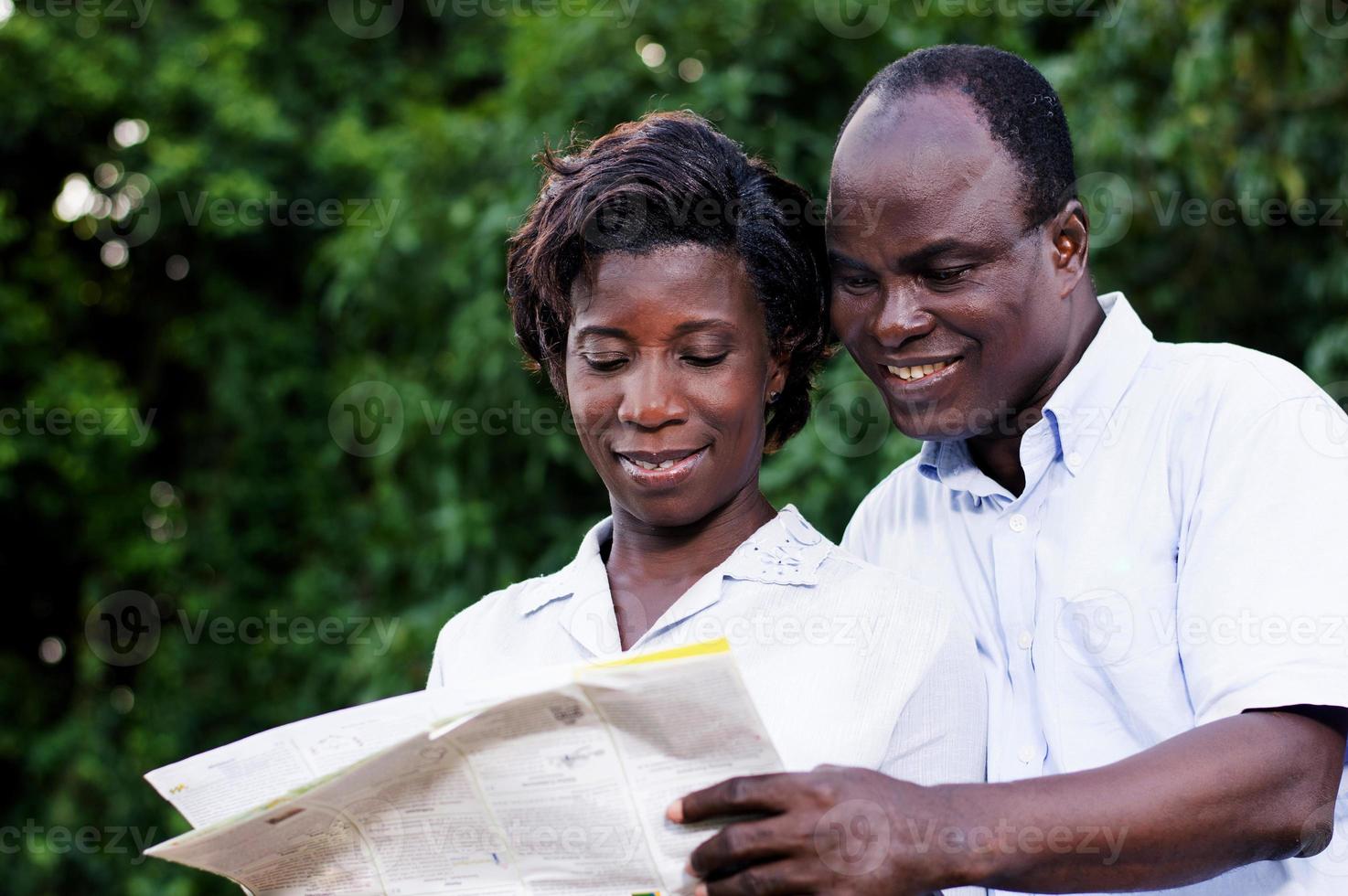 happy young couple traveling consult a map. photo