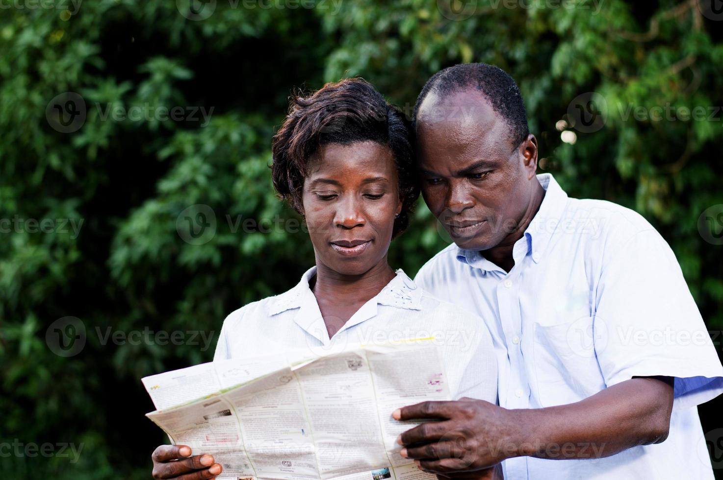 happy young couple traveling consult a map photo