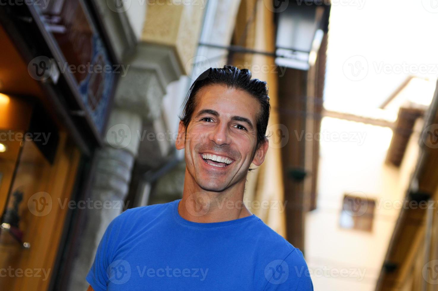 Attractive smiling man portrait in urban background photo