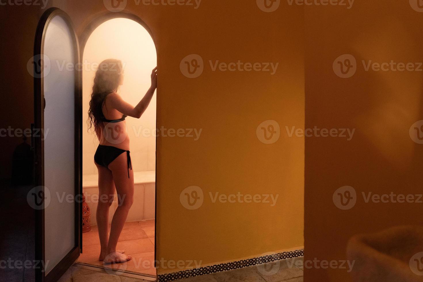 Young woman enjoying hammam or turkish bath photo