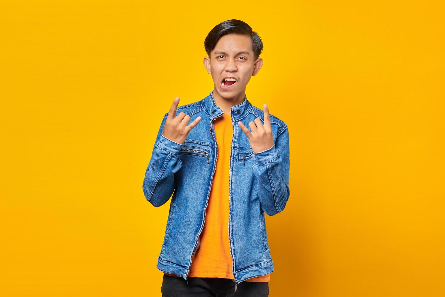 portrait of young asian man excited on yellow background photo